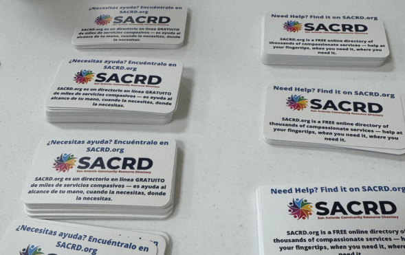 SACRD pocket cards in English and Spanish in stacks on a white table.