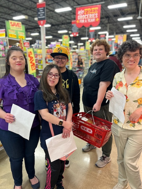 A group of individuals on a shopping trip at a grocery store.